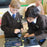 Students using CMPSR accessible music controller with a tablet