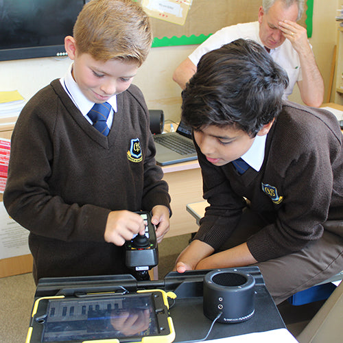 Students using CMPSR accessible music controller with a tablet