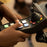 Person using CMPSR accessible music controller with joystick and buttons