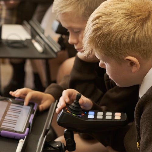 Student using CMPSR accessible music controller with a tablet