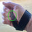 Bluetooth Tiny Switch hand strap positioning for assistive switch access