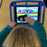 Child using Limitless Stylus adaptive stylus to access a tablet