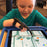 Child using Limitless Stylus adaptive touchscreen stylus on a tablet